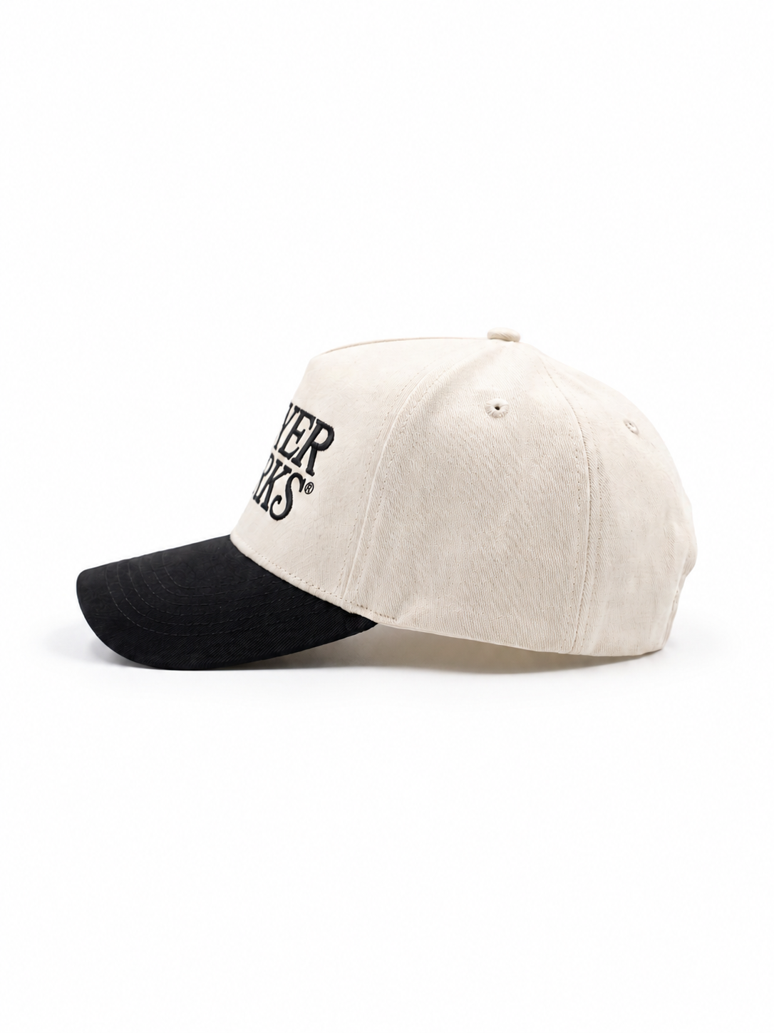 Two-tone cap with black visor and beige主体 on a white background